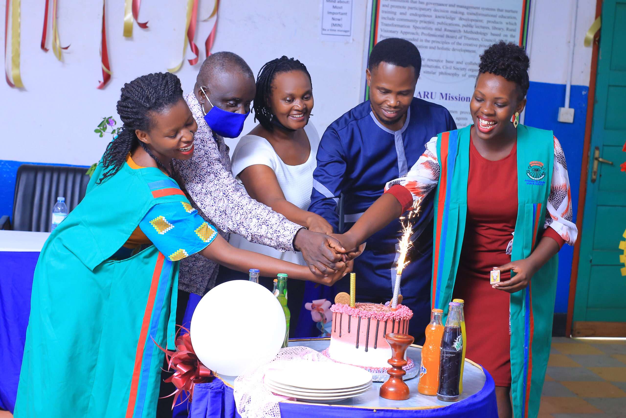 L-R The guild president elect H.E Osiime Rinah, Mr. A nthony Lwanga the Academic registrar, The University secretary Ms Keishanyu Rose, the Outgoing guild president Bless Sasira cutting a cake